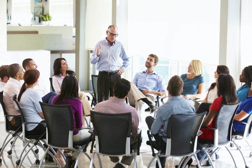 Businessman Addressing Multi-Cultural Office Staff Meeting